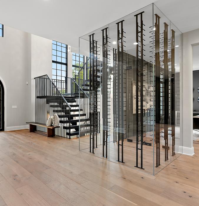 Picture of the grand foyer and wine case in a luxury home.