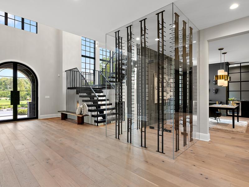 Picture of the grand foyer and wine case in a luxury home.